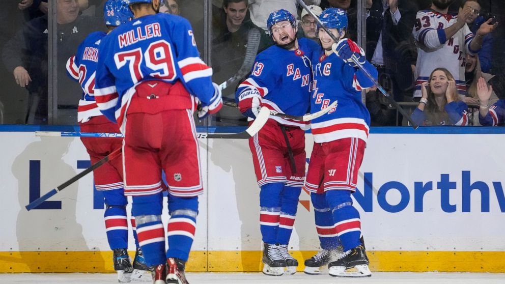New York Rangers left wing Alexis Lafrenière (13) celebrates after scoring in the third period of an NHL hockey game against the St. Louis Blues, Monday, Dec. 5, 2022, in New York. (AP Photo/John Minchillo)