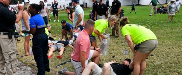 Spectators are tended to after a lightning strike on the course left several injured during a weather delay in the third round of the Tour Championship golf tournament Saturday, Aug. 24, 2019, in Atlanta. (AP Photo/John Amis)