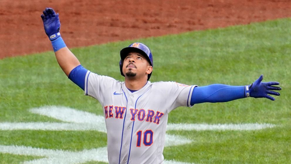 New York Mets' Eduardo Escobar celebrates as he crosses home plate after hitting a solo home run off Pittsburgh Pirates pitcher Bryse Wilson during the fourth inning of the first baseball game of a doubleheader in Pittsburgh, Wednesday, Sept. 7, 2022