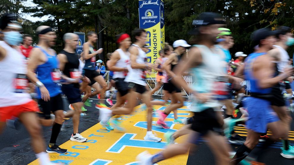 FILE - Runners cross the starting line of the 125th Boston Marathon, Monday, Oct. 11, 2021, in Hopkinton, Mass. Nonbinary athletes will be able to run in next year's Boston Marathon without having to qualify for the men's or women's divisions, race o