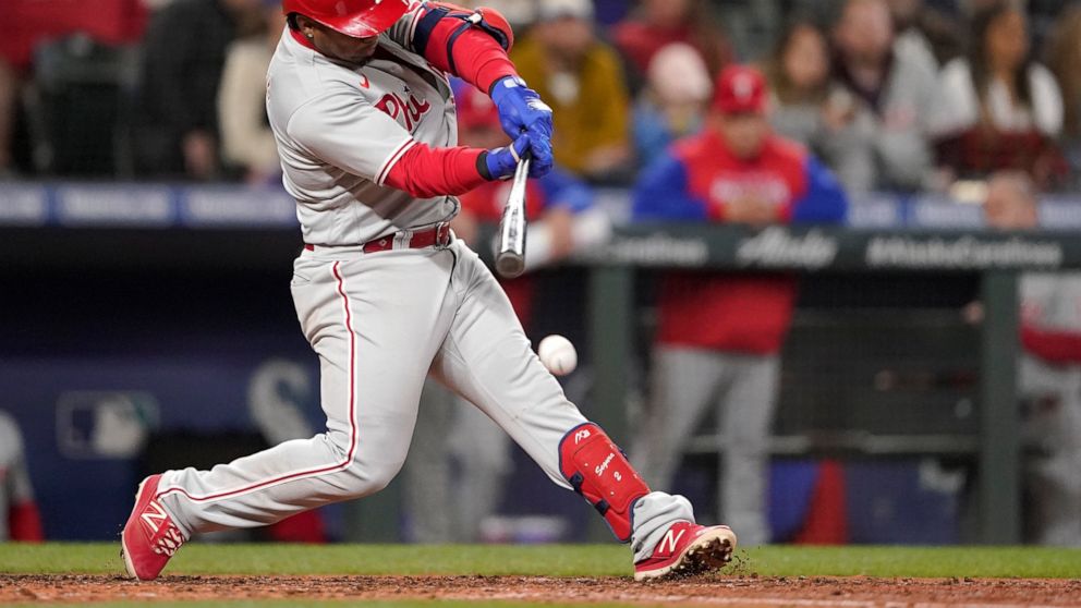 Philadelphia Phillies' Jean Segura hits into a force-out that allowed Nick Castellanos to score from third during the fifth inning of a baseball game against the Seattle Mariners, Monday, May 9, 2022, in Seattle. (AP Photo/Ted S. Warren)
