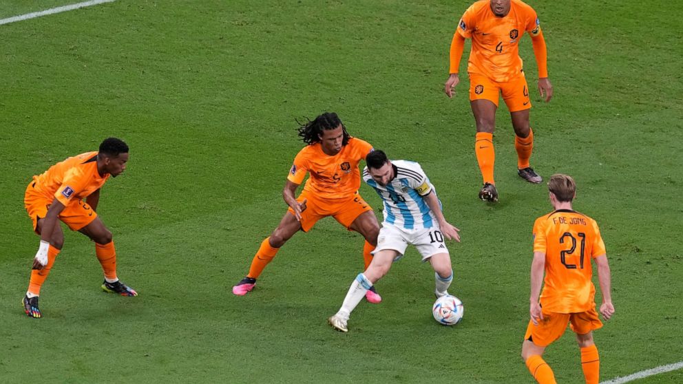 Argentina's Lionel Messi, centre, challenges for the ball with Denzel Dumfries of the Netherlands, left, Nathan Ake of the Netherlands, second left, Frenkie de Jong of the Netherlands, bottom right, Virgil van Dijk of the Netherlands, top right, duri