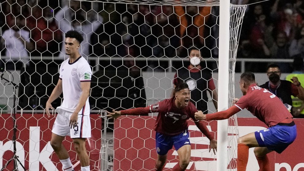 Costa Rica's Anthony Contreras, center, celebrates scoring his side's second goal against United States during a qualifying soccer match for the FIFA World Cup Qatar 2022 in San Jose, Costa Rica, Wednesday, March 30, 2022. (AP Photo/Moises Castillo)