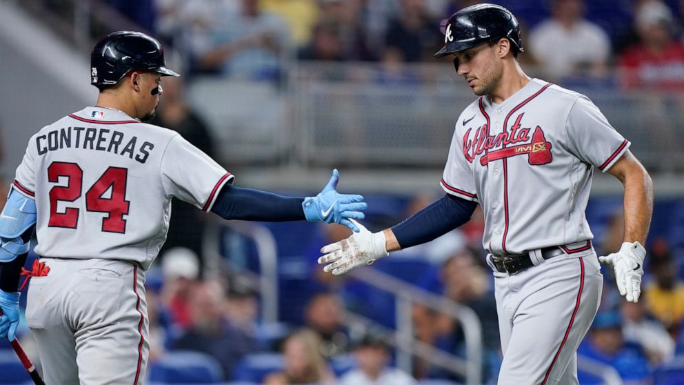Atlanta Braves' Matt Olson, right, is congratulated by William Contreras (24) after Olson hit a home run during the fourth inning of a baseball game against the Miami Marlins, Friday, Aug. 12, 2022, in Miami. (AP Photo/Wilfredo Lee)