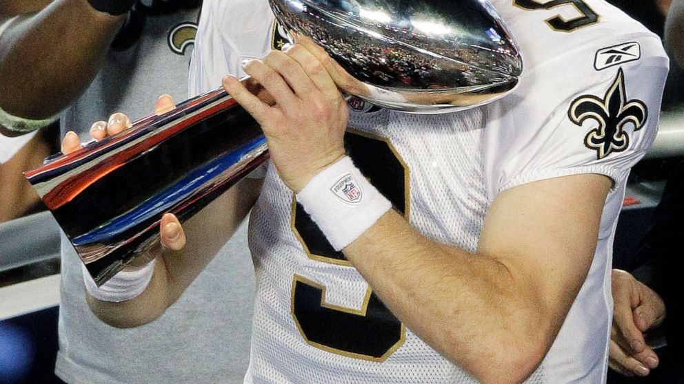 File-This Feb. 7, 2010, file photo shows New Orleans Saints quarterback Drew Brees (9) celebrating with the Vince Lombardi Trophy after the NFL Super Bowl XLIV football game against the Indianapolis Colts in Miami. Brees, the NFL’s leader in career c