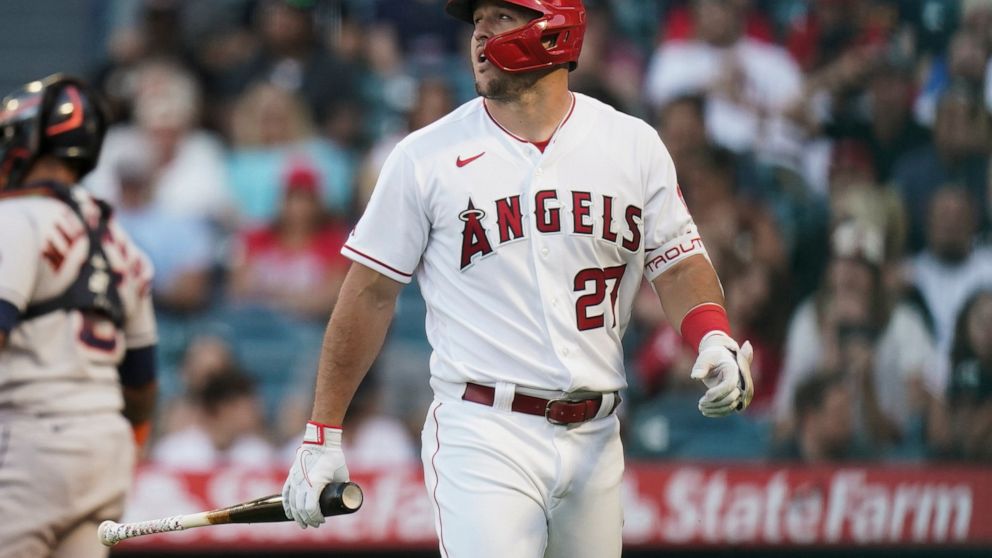 Los Angeles Angels' Mike Trout walks toward the dugout after striking out against the Houston Astros during the first inning of a baseball game Tuesday, July 12, 2022, in Anaheim, Calif. (AP Photo/Jae C. Hong)