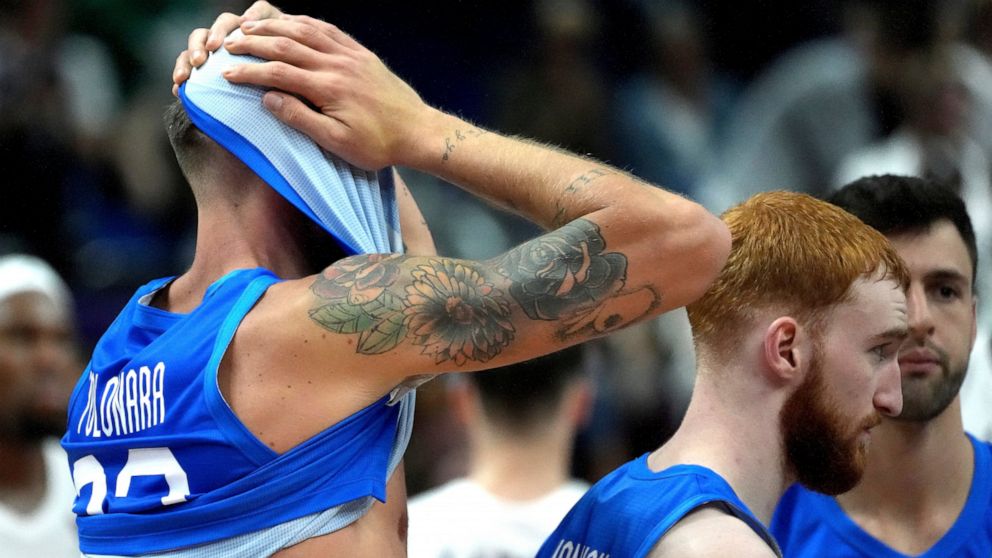 Italy's Achille Polonara, left, reacts after the Eurobasket quarter final basketball match between France and Italy in Berlin, Germany, Wednesday, Sept. 14, 2022. France defeated Italy by 93-85. (AP Photo/Michael Sohn)