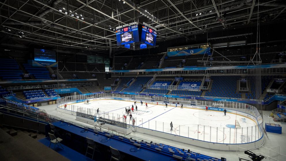 FILE - The China Ice Sports College hockey team practices on the ice during the Experience Beijing Ice Hockey Domestic Test Activity, a test event for the 2022 Beijing Winter Olympics, at the National Indoor Stadium in Beijing, Nov. 10, 2021. China's men's team is ranked 32nd in the world and is in a group with the United States and Canada, two of the medal favorites among the 12 teams going to the Winter Games in February. (AP Photo/Mark Schiefelbein, File)
