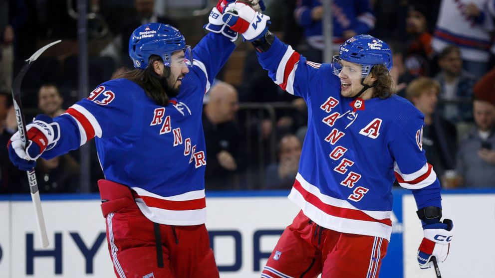 New York Rangers center Mika Zibanejad, left, congratulates Artemi Panarin after Panarin's goal against the New York Islanders during the first period of an NHL hockey game Thursday, Dec. 22, 2022, in New York. (AP Photo/John Munson)