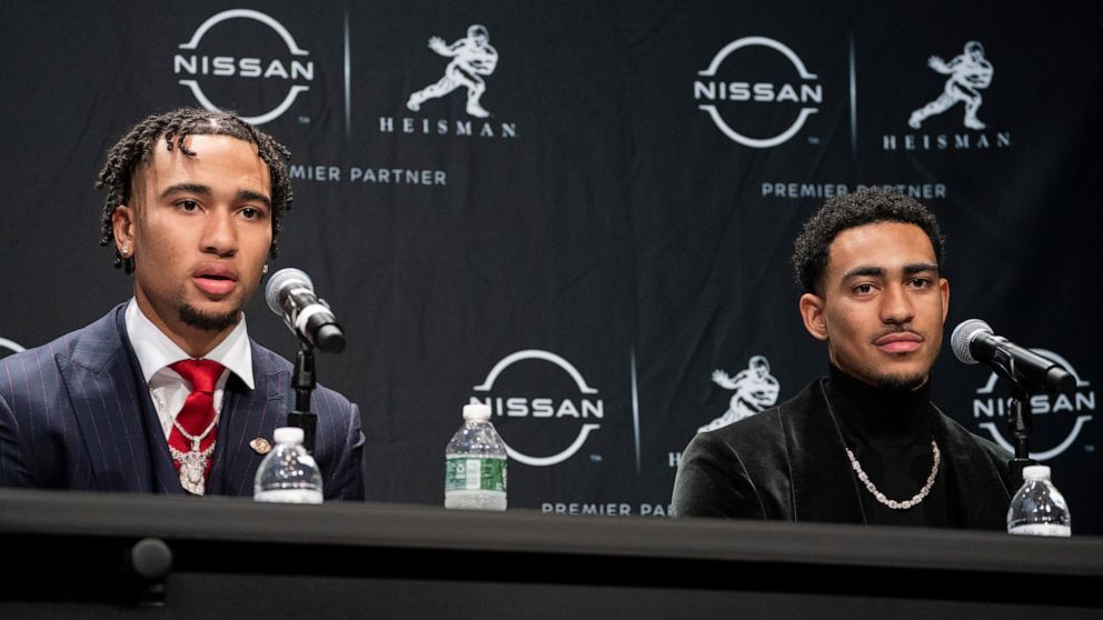 Heisman Trophy finalists Ohio State quarterback C.J. Stroud, left, speaks alongside Alabama quarterback Bryce Young during a news conference before attending the Heisman Trophy award ceremony, Saturday, Dec. 11, 2021, in New York. (AP Photo/John Minc