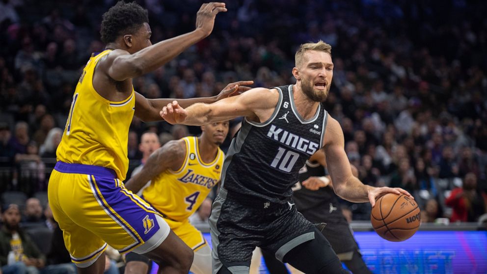 Sacramento Kings forward Domantas Sabonis (10) is defended by Los Angeles Lakers center Thomas Bryant (31) during the first quarter of an NBA basketball game in Sacramento, Calif., Wednesday, Dec. 21, 2022. (AP Photo/José Luis Villegas)