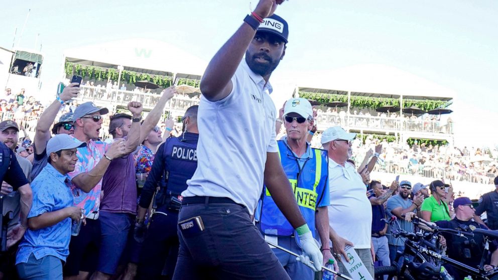 Sahith Theegala waves the gallery on the 18th hole during the third round of the Phoenix Open golf tournament Saturday, Feb. 12, 2022, in Scottsdale, Ariz. (AP Photo/Darryl Webb)