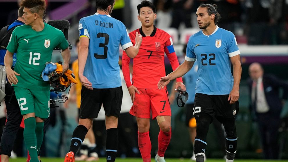 South Korea's Son Heung-min, second right, walks to greet Uruguay players at the end of the World Cup group H soccer match between Uruguay and South Korea, at the Education City Stadium in Al Rayyan , Qatar, Thursday, Nov. 24, 2022. (AP Photo/Frank A