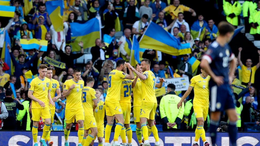 Ukraine's Roman Yaremchuk celebrates with teammates after scoring his side's second goal during the World Cup 2022 qualifying play-off soccer match between Scotland and Ukraine at Hampden Park stadium in Glasgow, Scotland, Wednesday, June 1, 2022. (A