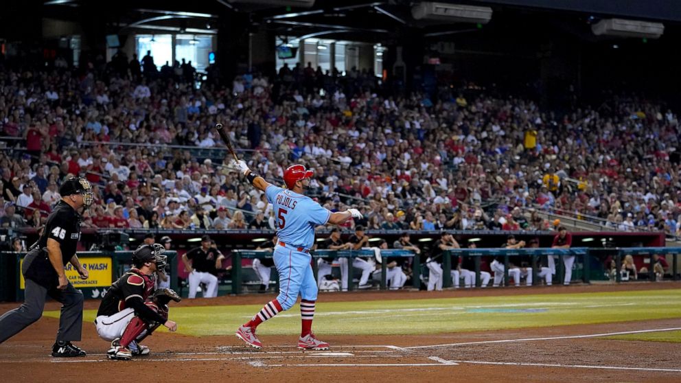 St. Louis Cardinals' Albert Pujols watches his solo home run take flight against the Arizona Diamondbacks during the second inning of a baseball game, Saturday, Aug. 20, 2022, in Phoenix. (AP Photo/Matt York)
