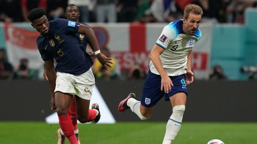 England's Harry Kane, right, and France's Aurelien Tchouameni challenge for the ball during the World Cup quarterfinal soccer match between England and France, at the Al Bayt Stadium in Al Khor, Qatar, Saturday, Dec. 10, 2022. (AP Photo/Frank Augstein)