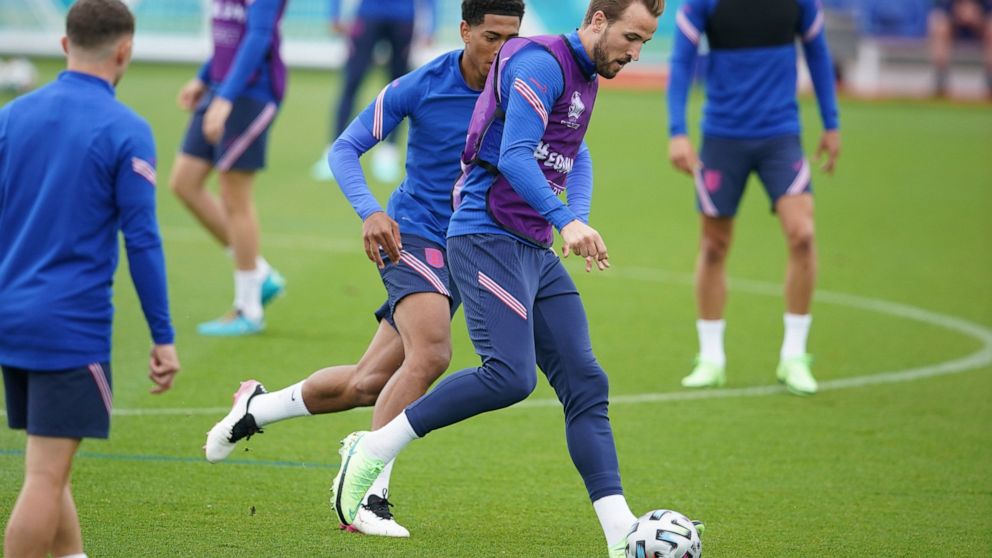 England's Harry Kane is challenged by Jude Bellingham during a training session at St George's Park, Burton upon Trent, England, Saturday July 10, 2021, ahead of their Euro 2020 soccer championship final match against Italy at Wembley Stadium on Sund