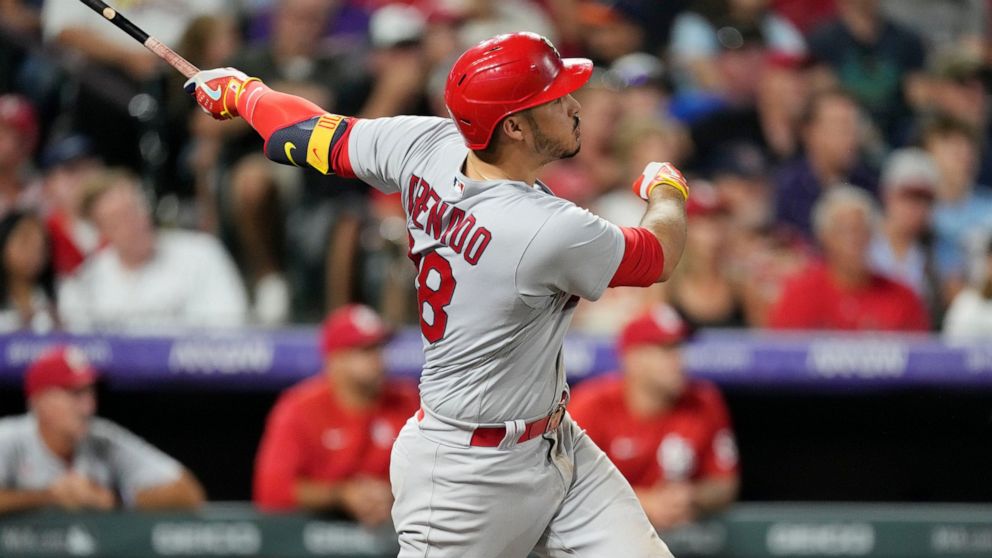 St. Louis Cardinals' Nolan Arenado watches his solo home run off Colorado Rockies relief pitcher Austin Gomber during the sixth inning of a baseball game Wednesday, Aug. 10, 2022, in Denver. (AP Photo/David Zalubowski)