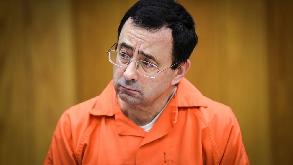 FILE - In this Feb. 2, 2018, file photo, Larry Nassar listens as Melissa Alexander Vigogne gives her victim statement in Eaton County Circuit Court in Charlotte, Mich. USA Gymnastics is overhauling its Safe Sport policy in hopes of providing better p