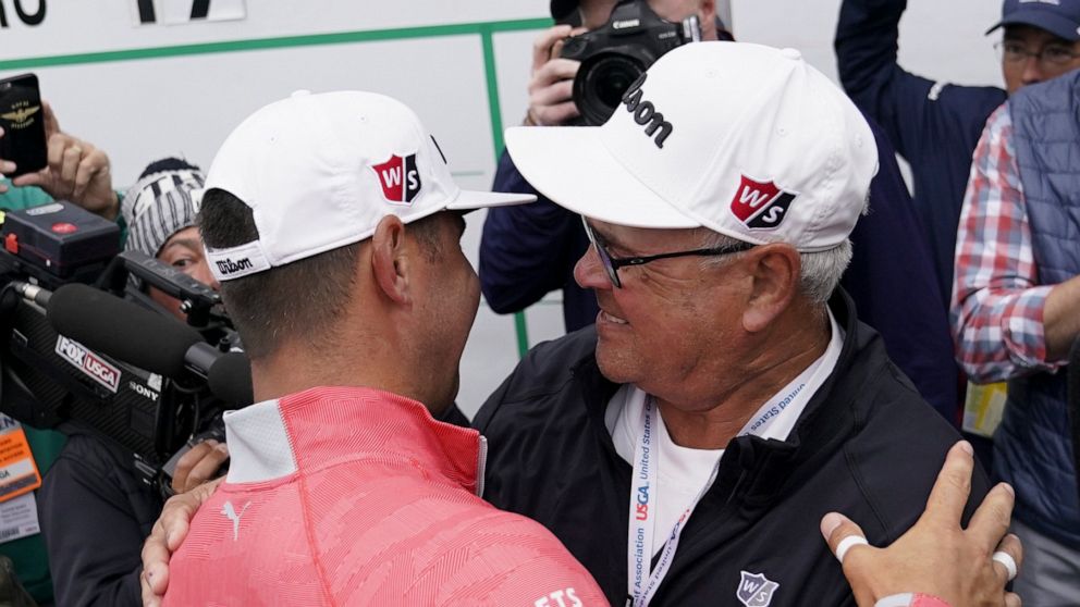Gary Woodland celebrates after winning the U.S. Open Championship golf tournament with his father Dan, Sunday, June 16, 2019, in Pebble Beach, Calif. (AP Photo/Carolyn Kaster)