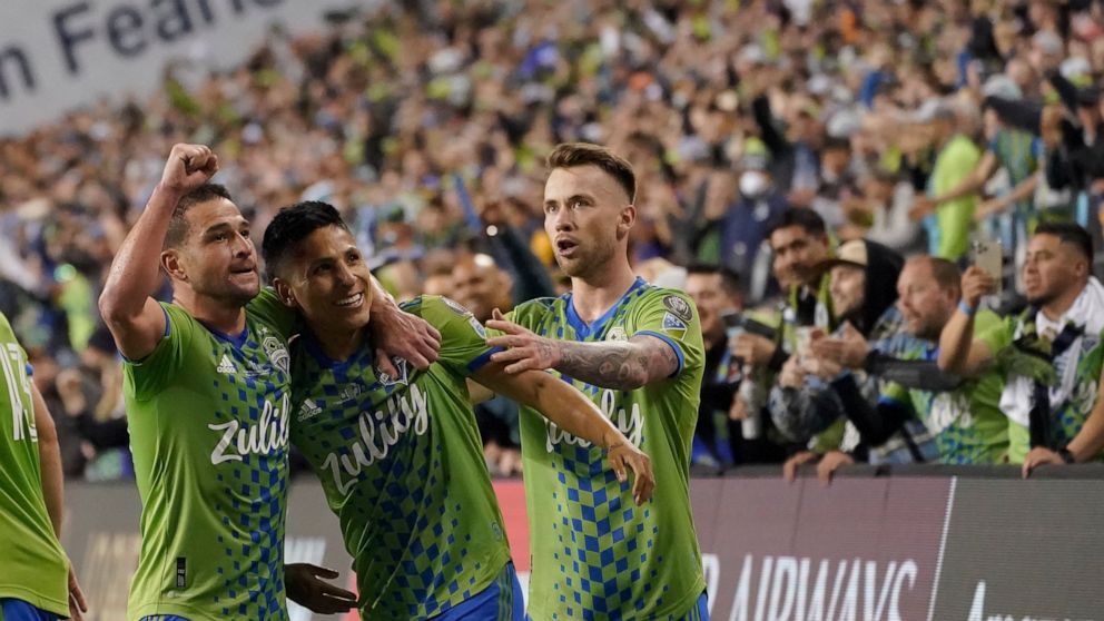 United States' Seattle Sounders forward Raul Ruidiaz (9) celebrates his goal with teammates during the second half of the second leg of the CONCACAF Champions League soccer final against Mexico's Pumas, Wednesday, May 4, 2022, in Seattle. (AP Photo/T