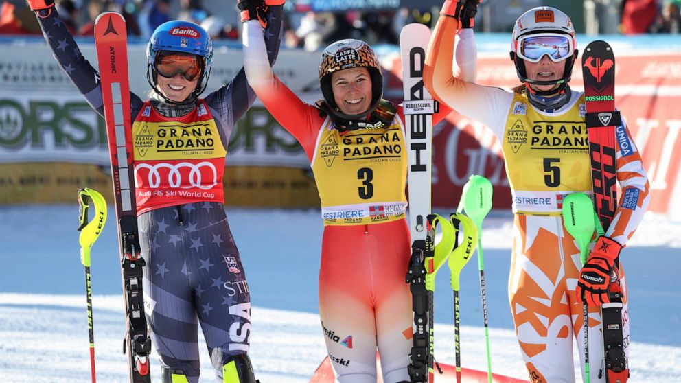 Switzerland's Wendy Holdener, center, winner of an alpine ski, women's World Cup slalom, celebrates with second-placed United States' Mikaela Shiffrin, left, and third-placed Slovakia's Petra Vlhova, in Sestriere, Italy, Sunday, Dec.11, 2022. (AP Pho