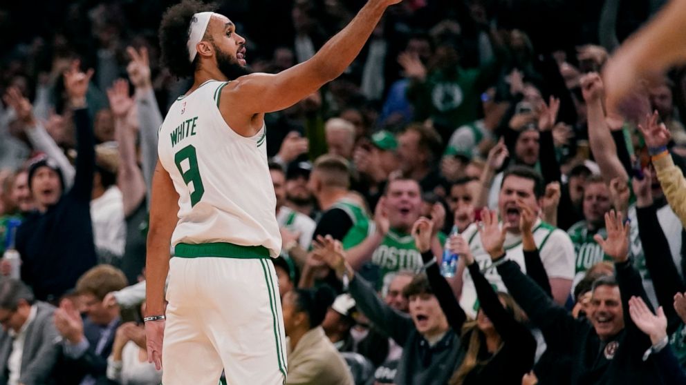 Boston Celtics guard Derrick White celebrates with fans after hitting a 3-pointer in the final minute of the second half of an NBA basketball game against the Oklahoma City Thunder, Monday, Nov. 14, 2022, in Boston. (AP Photo/Charles Krupa)
