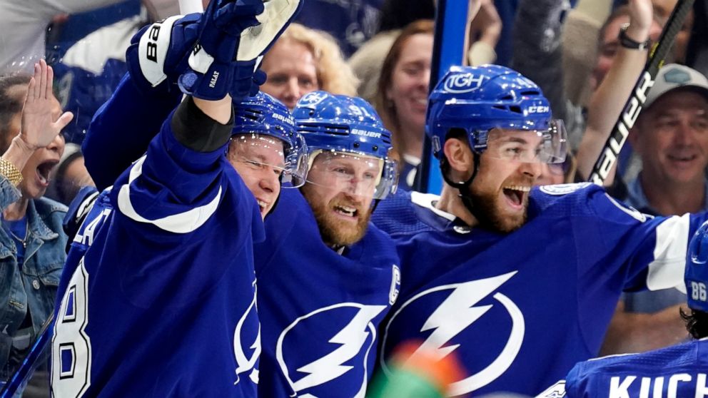 Tampa Bay Lightning center Steven Stamkos, center, celebrates his goal against the New York Rangers with Jan Rutta, right and Tampa Bay Lightning left wing Ondrej Palat, left, during the second period in Game 6 of the NHL hockey Stanley Cup playoffs 