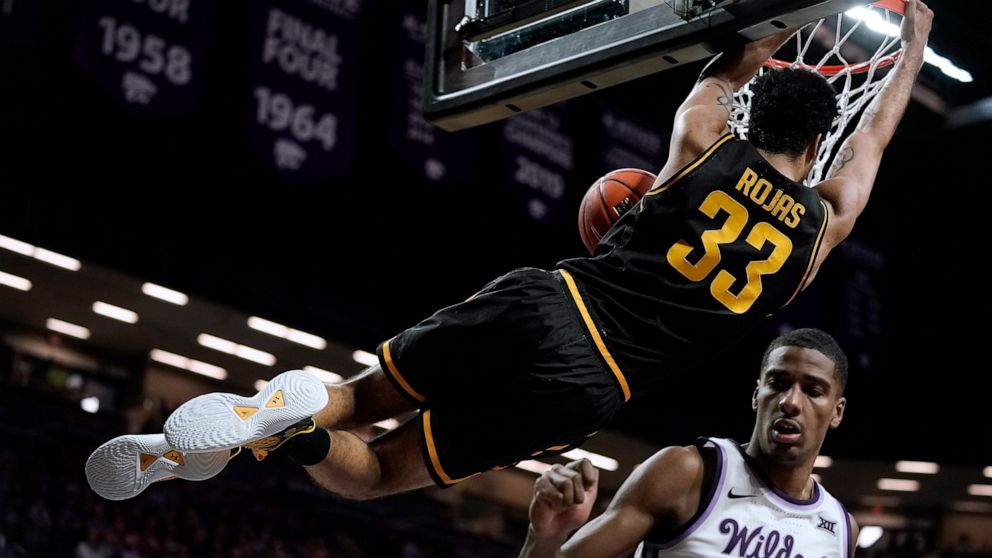 Wichita State forward James Rojas (33) gets past Kansas State forward David N'Guessan (3) to dunk the ball during the first half of an NCAA college basketball game Saturday, Dec. 3, 2022, in Manhattan, Kan. (AP Photo/Charlie Riedel)