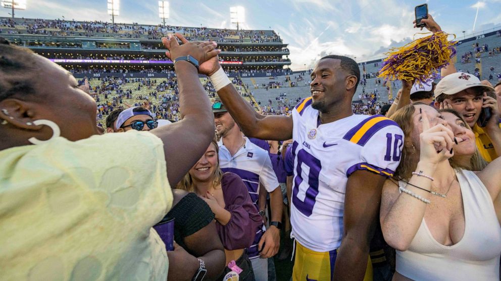LSU wide receiver Jaray Jenkins (10) celebrates with fans who came onto the field after LSU defeated Mississippi in an NCAA college football game in Baton Rouge, La., Saturday, Oct. 22, 2022. (AP Photo/Matthew Hinton)