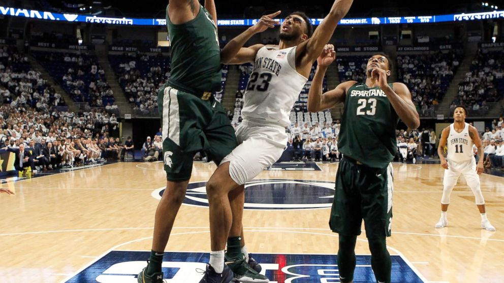 Penn State's Josh Reaves (23) goes to the basket as Michigan State's Nick Ward (44) defends during first-half action of an NCAA college basketball game in State College, Pa. Sunday, Jan. 13, 2019. (AP Photo/Chris Knight)
