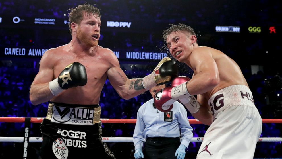 FILE - Canelo Alvarez lands a punch against Gennady Golovkin in the 12th round during a middleweight title boxing match, on Sept. 15, 2018, in Las Vegas. Four years have passed since the tight rematch between Canelo Alvarez and Gennady Golovkin that 