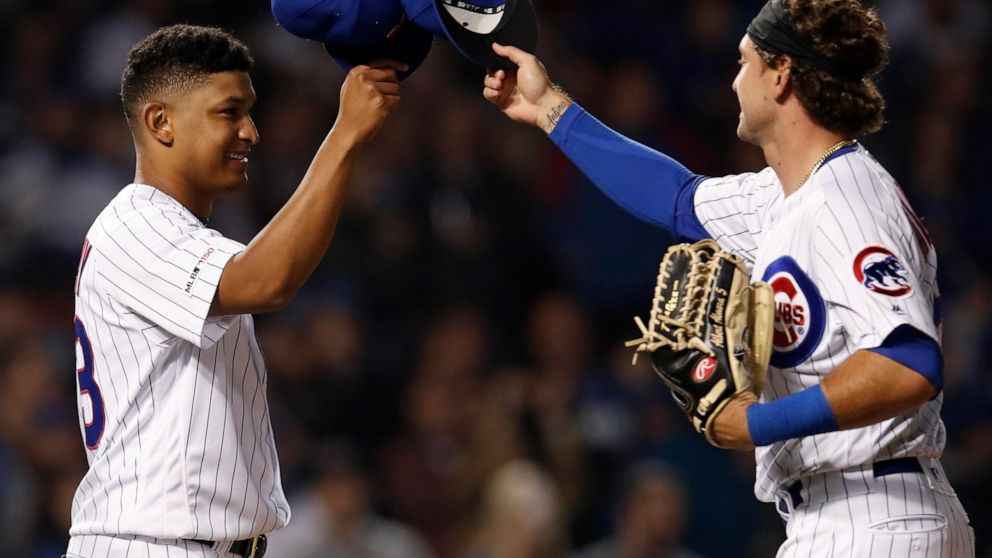 Chicago Cubs' Adbert Alzolay, left, is congratulated by Albert Almora Jr. on his first win in the majors, against the New York Mets in a baseball game Thursday, June 20, 2019, in Chicago. The Cubs won 7-4.(AP Photo/Jim Young)
