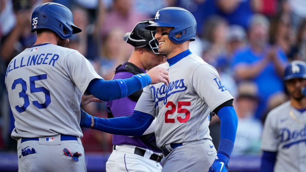 Los Angeles Dodgers' Cody Bellinger, left, congratulates Trayce Thompson, who hit a two-run home run off Colorado Rockies starting pitcher Chad Kuhl during the second inning of a baseball game Friday, July 29, 2022, in Denver. (AP Photo/David Zalubowski)