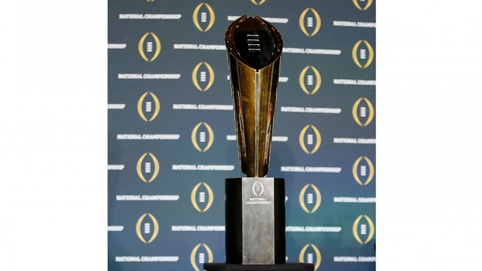 FILE - The national championship trophy is seen before a new conference for the NCAA college football playoff championship game between Clemson and Alabama, Sunday, Jan. 10, 2016, in Glendale, Ariz. The College Football Playoff announced Thursday, De