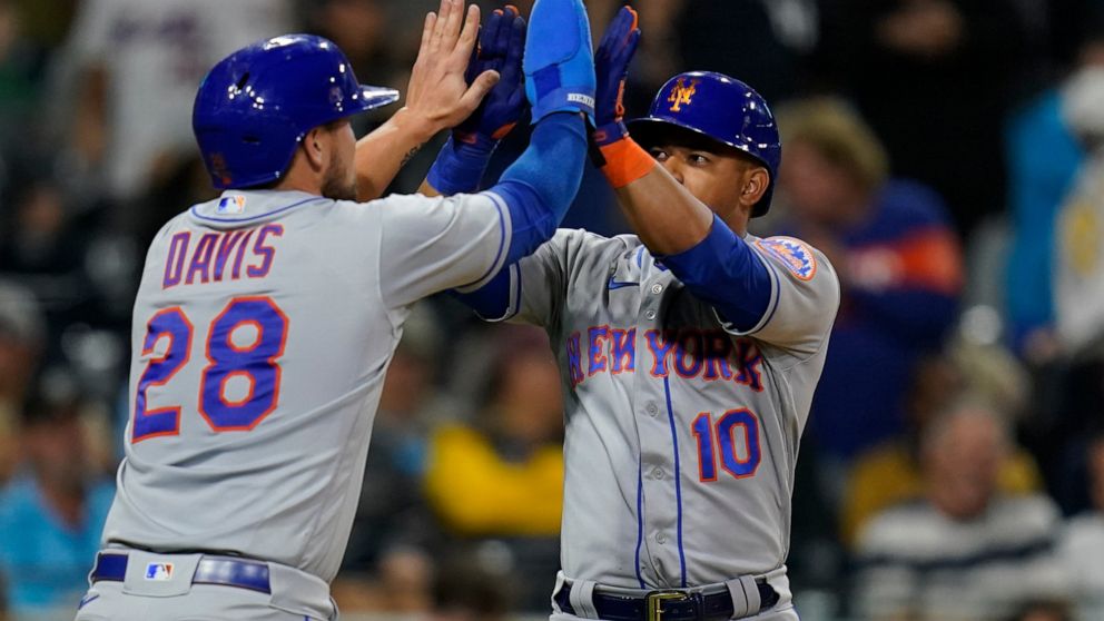 New York Mets' Eduardo Escobar, right, reacts with teammate J.D. Davis (28) after hitting a two-run home run during the eighth inning of a baseball game against the San Diego Padres, Monday, June 6, 2022, in San Diego. (AP Photo/Gregory Bull)