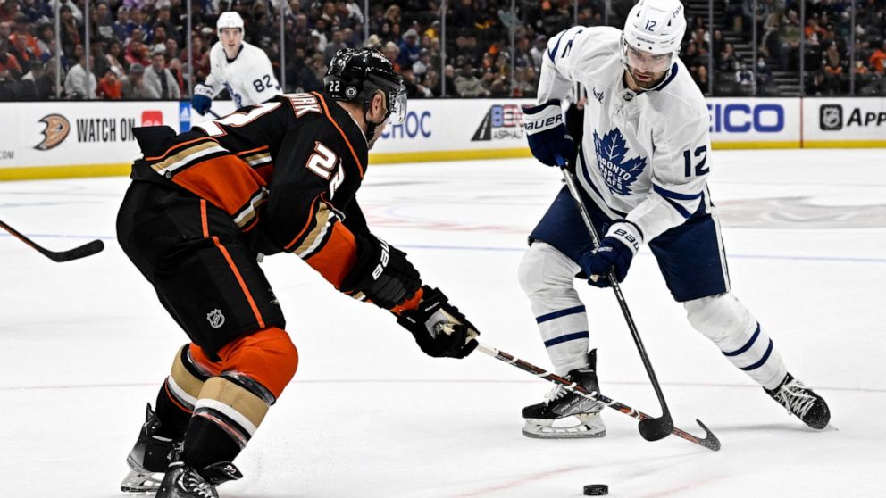 Toronto Maple Leafs center Zach Aston-Reese, right, shoots against Anaheim Ducks defenseman Kevin Shattenkirk, left, during the second period of an NHL hockey game in Anaheim, Calif., Sunday, Oct. 30, 2022. (AP Photo/Alex Gallardo)