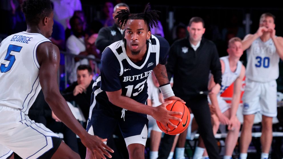 In a photo provided by Bahamas Visual Services, Butler's Jayden Taylor (13) is defended by BYU's Gideon George during an NCAA college basketball game in the Battle 4 Atlantis at Paradise Island, Bahamas, Thursday, Nov. 24, 2022. (Tim Aylen/Bahamas Vi