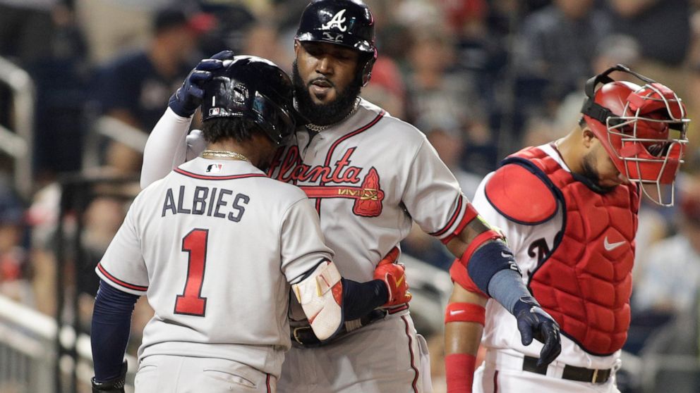 Atlanta Braves' Marcell Ozuna, right, celebrates with teammate Ozzie Albies (1) after hitting a two-run home run during the third inning of a baseball game against the Washington Nationals, Monday, June 13, 2022, in Washington. (AP Photo/Luis M. Alvarez)