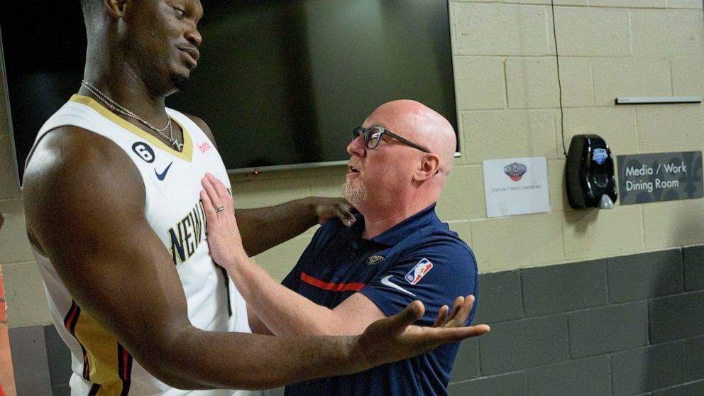 New Orleans Pelicans power forward Zion Williamson (1) jokes with David Griffin, executive vice president of basketball operations, during the NBA Pelicans basketball media day in New Orleans, Monday, Sept. 26, 2022. (AP Photo/Matthew Hinton)