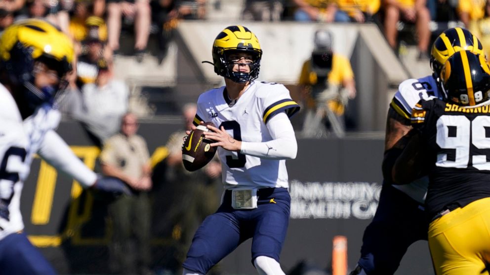 Michigan quarterback J.J. McCarthy (9) looks to pass during the first half of an NCAA college football game against Iowa, Saturday, Oct. 1, 2022, in Iowa City, Iowa. (AP Photo/Charlie Neibergall)