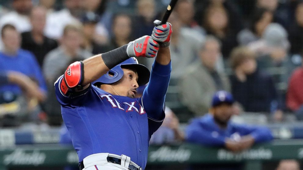 Texas Rangers' Ronald Guzman follows through on a three-run home run during the fifth inning of a baseball game against the Seattle Mariners, Tuesday, May 28, 2019, in Seattle. (AP Photo/Ted S. Warren)