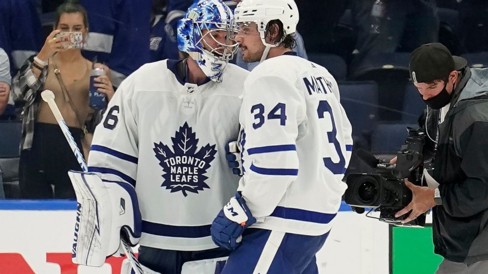 Toronto Maple Leafs goaltender Jack Campbell (36) and center Auston Matthews (34) celebrate after the team defeated the Tampa Bay Lightning during Game 3 of an NHL hockey first-round playoff series Friday, May 6, 2022, in Tampa, Fla. (AP Photo/Chris 
