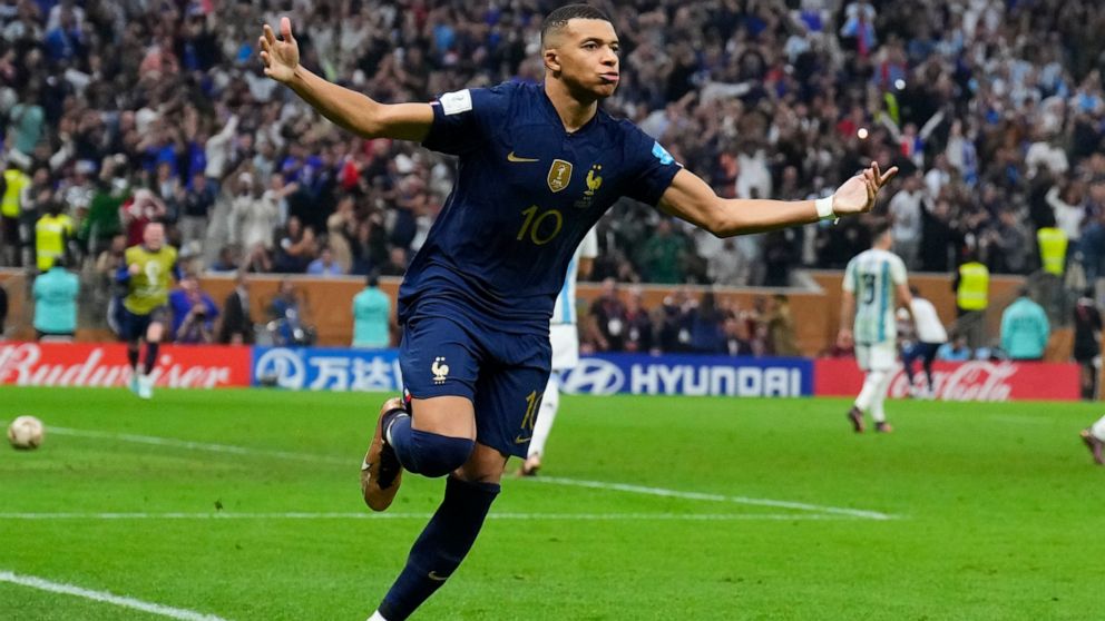 France's Kylian Mbappe celebrates scoring from the penalty spot his side's third goal during the World Cup final soccer match between Argentina and France at the Lusail Stadium in Lusail, Qatar, Sunday, Dec. 18, 2022. (AP Photo/Natacha Pisarenko)