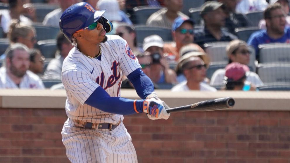 New York Mets' Francisco Lindor watches the ball after hitting an an RBI-double in the sixth inning of game one of a double header baseball game against the Atlanta Braves, Saturday, Aug. 6, 2022, in New York. (AP Photo/Mary Altaffer)