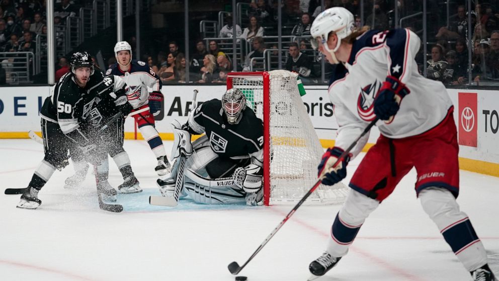 Los Angeles Kings defenseman Sean Durzi (50) and goaltender Jonathan Quick (32) defend against Columbus Blue Jackets left wing Patrik Laine (29) during the first period of an NHL hockey game Saturday, April 16, 2022, in Los Angeles. (AP Photo/Ashley 