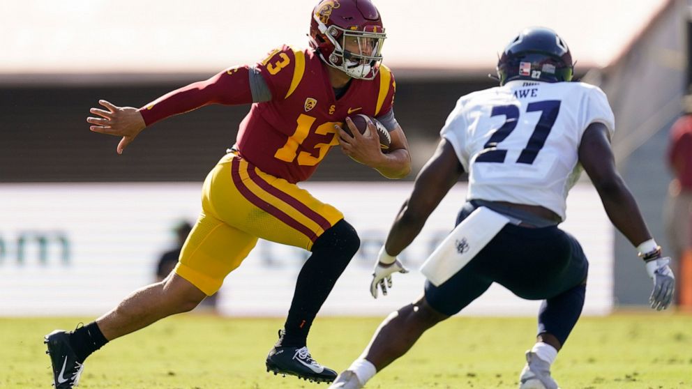 Southern California quarterback Caleb Williams (13) runs the ball against Rice linebacker Andrew Awe (27) during the first half of an NCAA college football game in Los Angeles, Saturday, Sept. 3, 2022. (AP Photo/Ashley Landis)