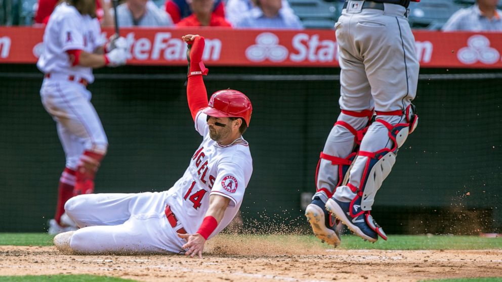 Los Angeles Angels' Tyler Wade scores next to Cleveland Guardians catcher Austin Hedges during the seventh inning of a baseball game in Anaheim, Calif., Thursday, April 28, 2022. (AP Photo/Alex Gallardo)