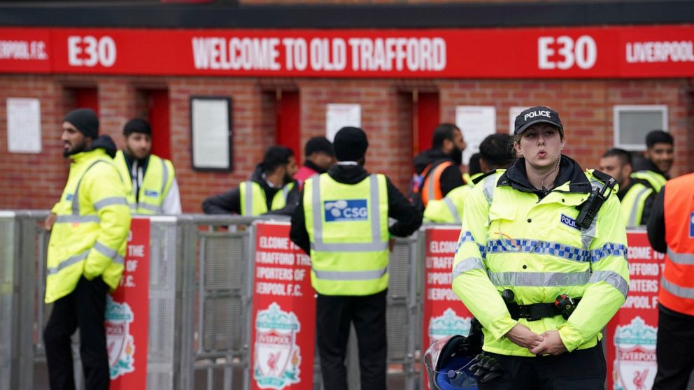 Police officers stand guard before the English Premier League soccer match against Liverpool at Old Trafford stadium in Manchester, England, Monday, Aug 22, 2022. (AP Photo/Dave Dave Thompson)