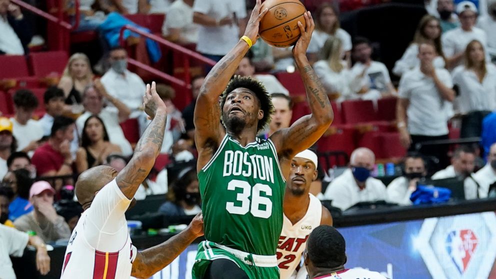 Boston Celtics guard Marcus Smart (36) drives to the basket as Miami Heat forward P.J. Tucker (17) defends during the second half of Game 7 of the NBA basketball Eastern Conference finals playoff series, Sunday, May 29, 2022, in Miami. (AP Photo/Lynn
